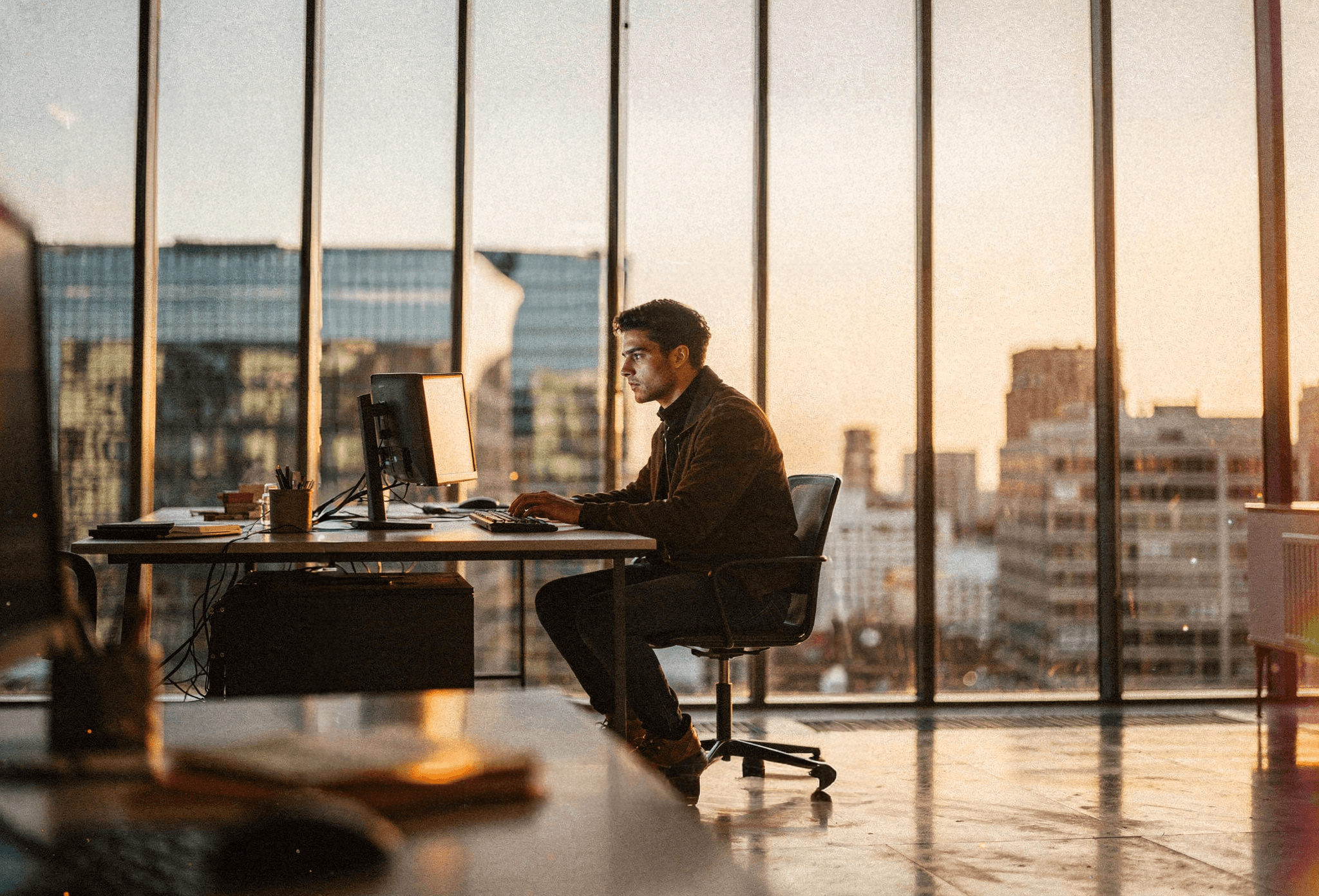 Talent working at a modern desk with city skyline view